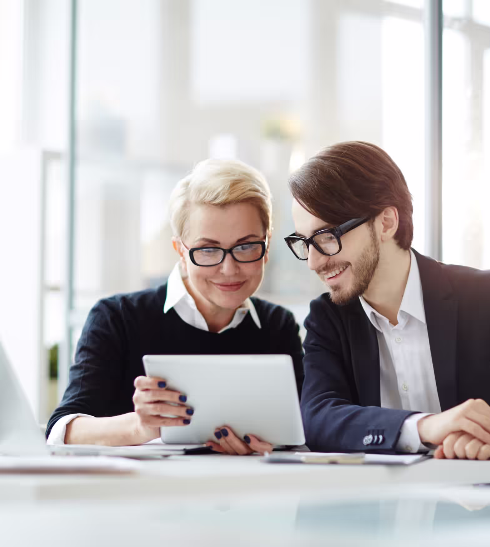 Two persons looking at a tablet